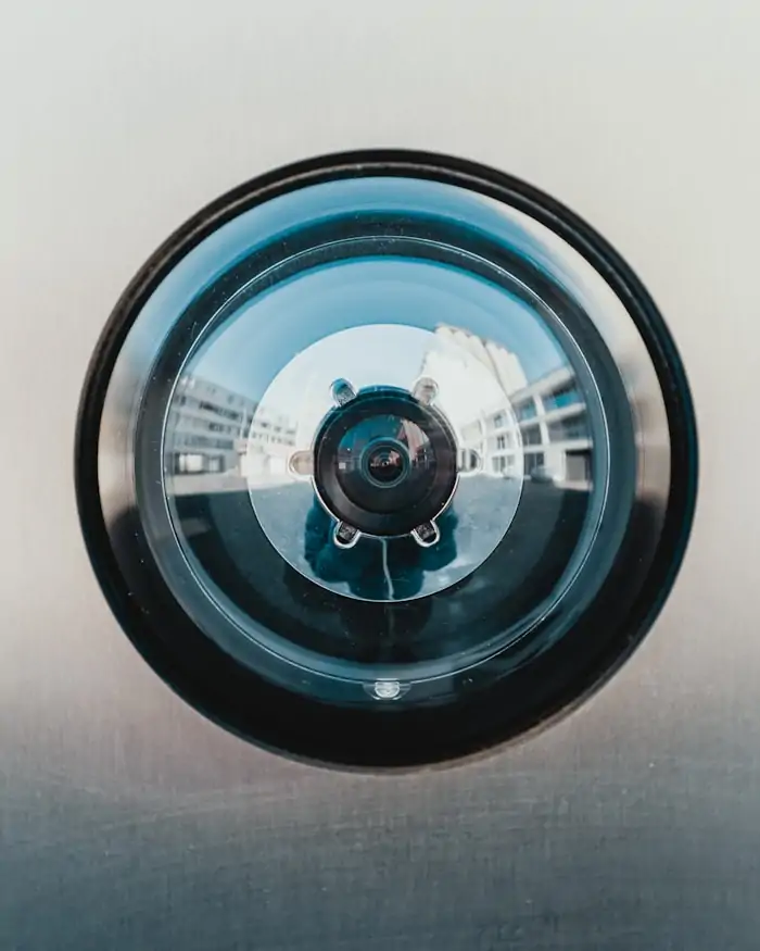 Close-up of the lens assembly of a dome surveillance camera.