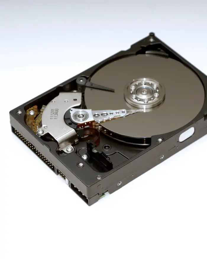 An opened hard disk drive with its platter and read-write head exposed.