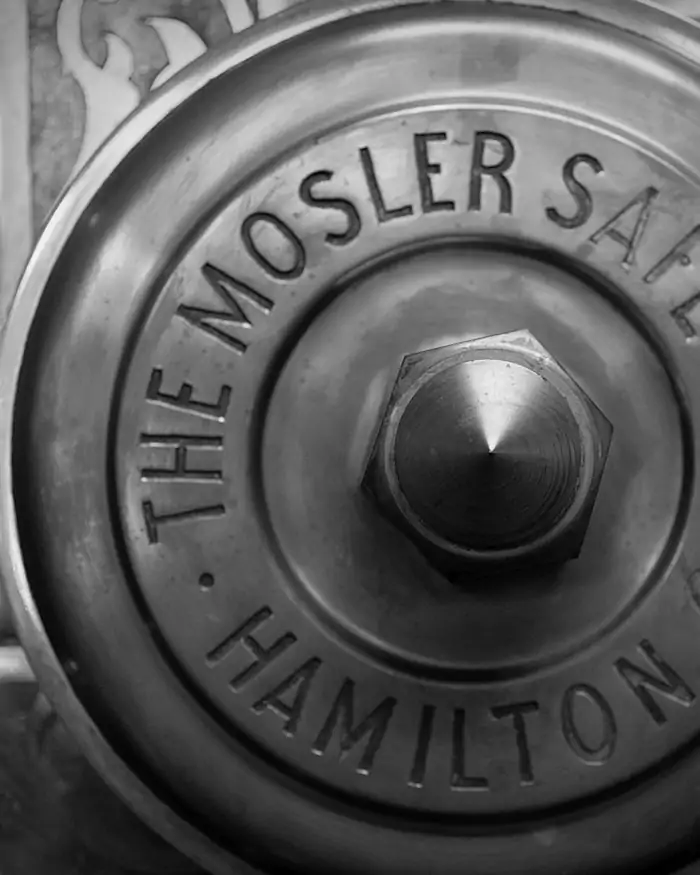 The combination dial of a heavy steel safe, photographed in monochrome.