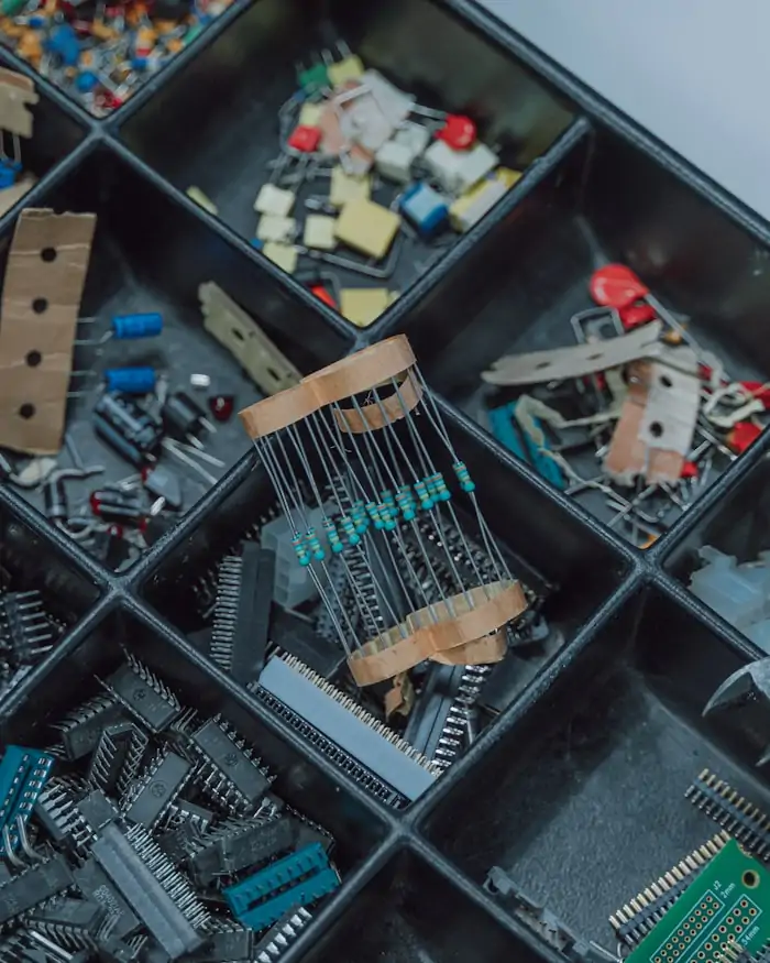 A compartmented tray of electronic components and small hand tools.